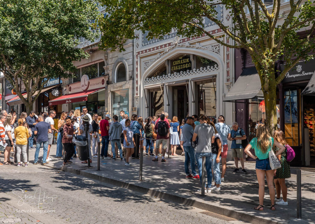 Tourists and fans queue to enter the famous Lello bookshop in Oporto, Portugal