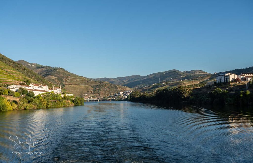 Croft and Royal Oporto port winery buildings on the banks of the River Douro in Portugal with Pinhao in the distance.