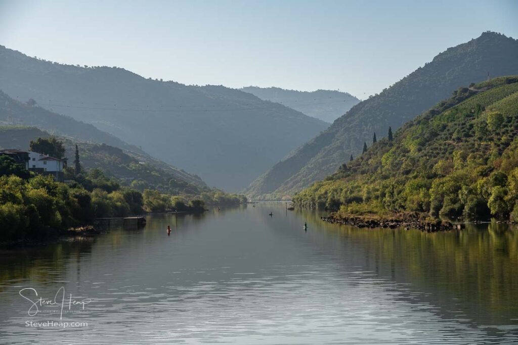 River Douro flowing through narrow gorge with terraces of wines and vineyards on the banks in Portugal near Pinhao