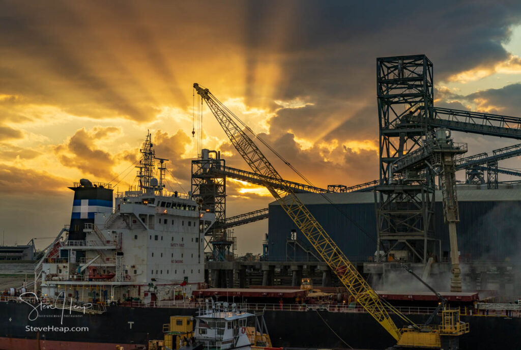 Dramatic sunset over the machinery of loading dock at Port Allen by the Mississippi river in Baton Rouge Louisiana. Prints available in my online store
