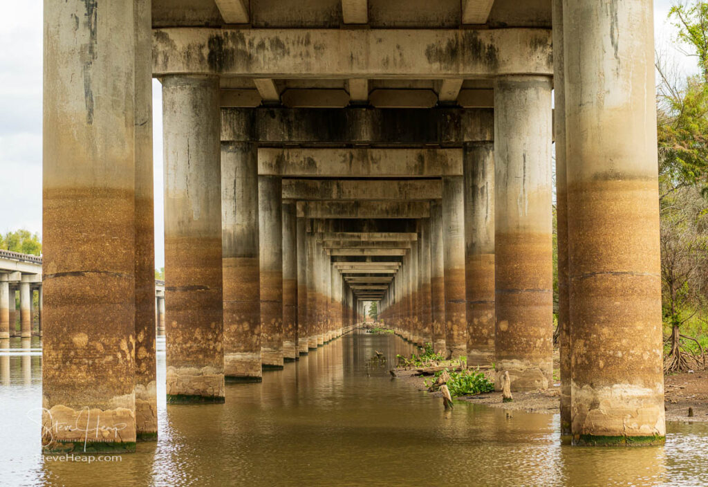 Receding pillars of the I-10 interstate bridge over the bayou of Atchafalaya basin near Baton Rouge Louisiana. Prints in my online store