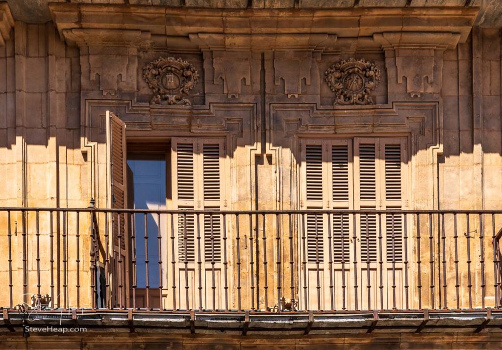 Ornate balconies and stone carvings around the windows and doors of apartments in Plaza Mayor in Salamanca