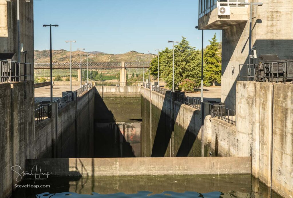 Barragem do Pocinho dam on the Douro river in Portugal as cruise boat waits by lock gates