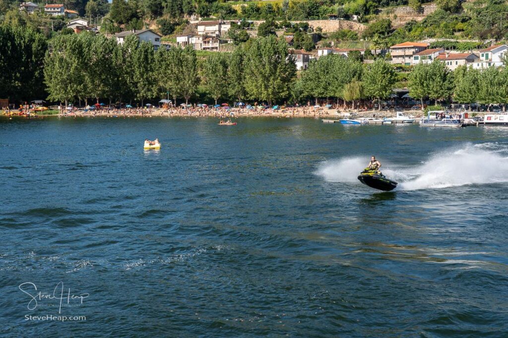 Sea Doo watercraft rider in the river by the Bitetos beach in Douro valley near Porto