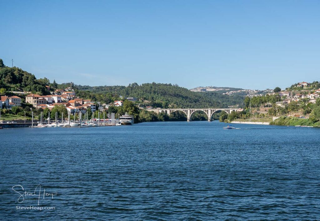 Small marina with power boats and docked river cruise boat in the Douro valley near Porto