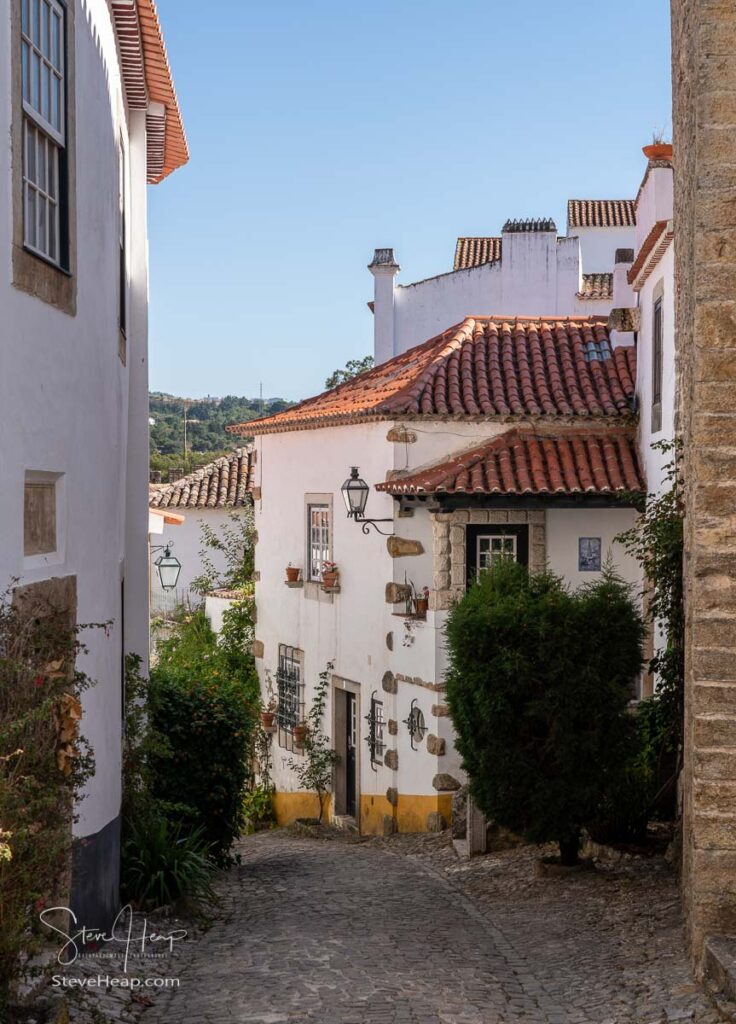 Steep street in the old medieval walled city of Obidos in Portugal