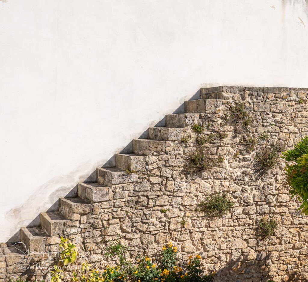 Unusual stone stairs leading nowhere in the old medieval walled city of Obidos in Portugal