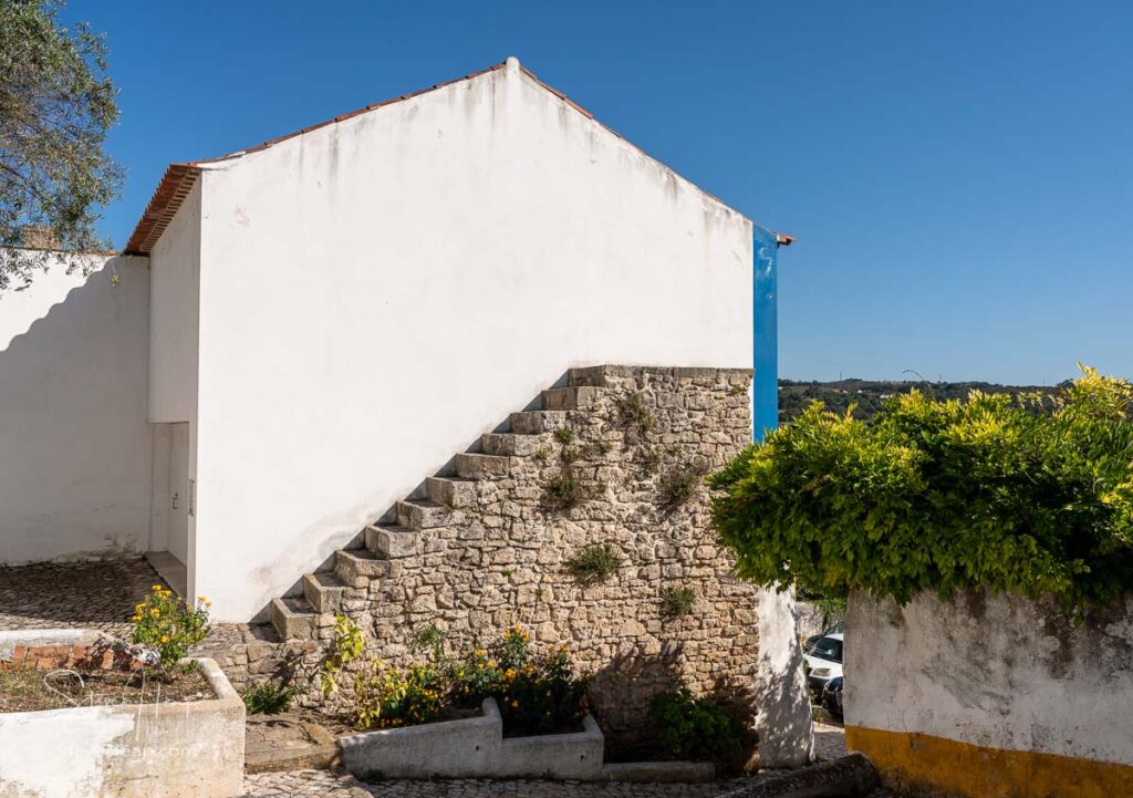 Unusual stone stairs leading nowhere in the old medieval walled city of Obidos in Portugal