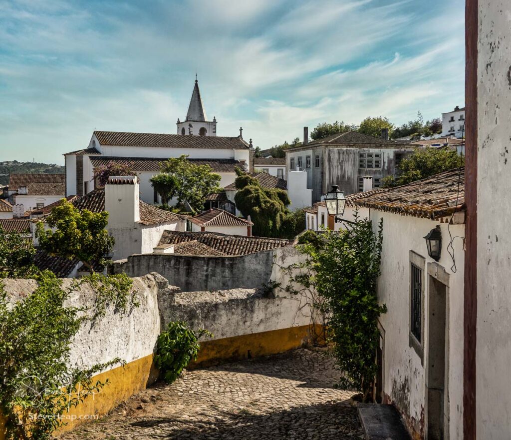 Narrow alley in the old medieval walled city of Obidos in Portugal