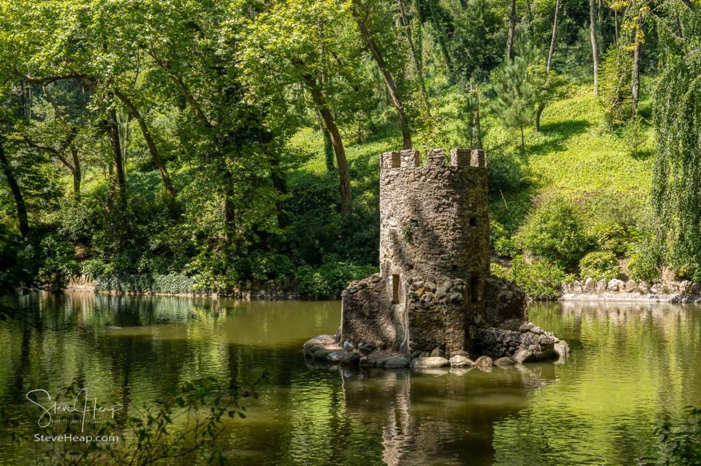 Stone tower bird house in lake in the gardens surrounding the Pena Palace above Sintra