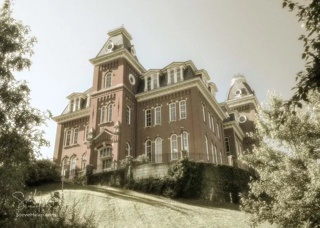 Antique sepia look of the historic Woodburn Hall at West Virginia University or WVU in Morgantown WV seen from below and looking up towards the rear and side of the building.