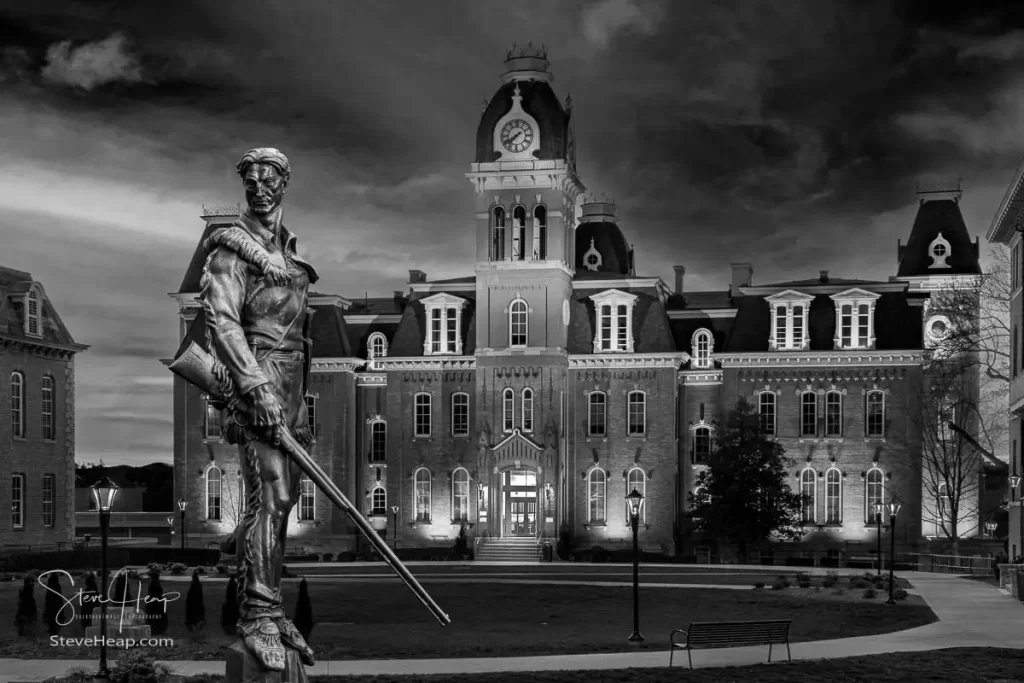 Dramatic black and white monochrome image of Woodburn Hall at West Virginia University or WVU in Morgantown WV with the famous Mountaineer statue composited into the photo. Perfect for a graduation gift for a student or for the wall of a faculty office