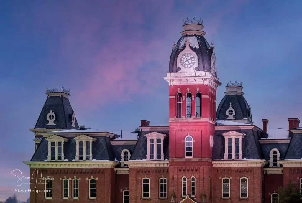 Dramatic image of the clock tower of Woodburn Hall at West Virginia University or WVU in Morgantown WV after a snow fall on the historic building. Perfect for a graduation gift for your student or to grace the wall of a faculty office!