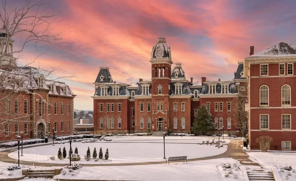 Dramatic image of a sunset over Woodburn Hall at West Virginia University or WVU in Morgantown WV after a snow fall around the historic building. And yes, I replaced the sky in this image to make a perfect graduation gift for your student or to grace the wall of a faculty office! It is only what a painter would have done!
