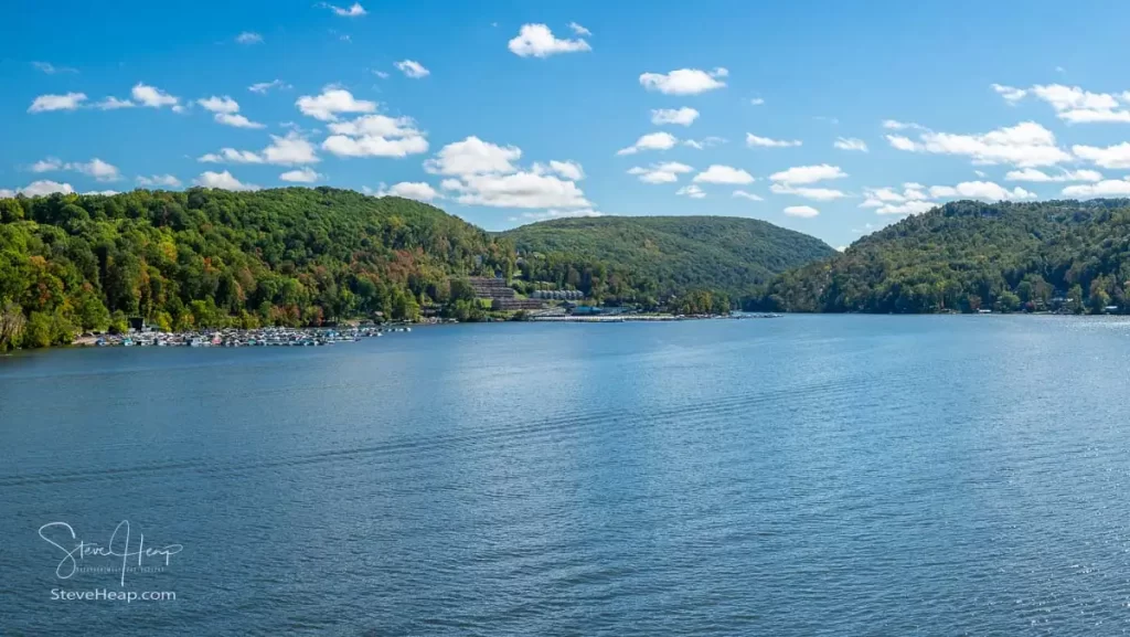 Panorama of the early autumn fall colors surrounding Cheat Lake from the waterside near Morgantown West Virginia