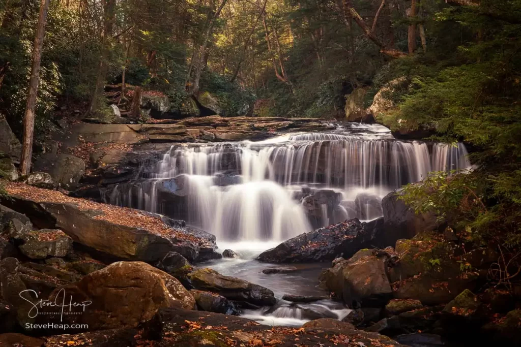 Cascade of waterfall during autumn with blurred motion on Deckers Creek running by Route 7 near Masontown in Preston County West Virginia