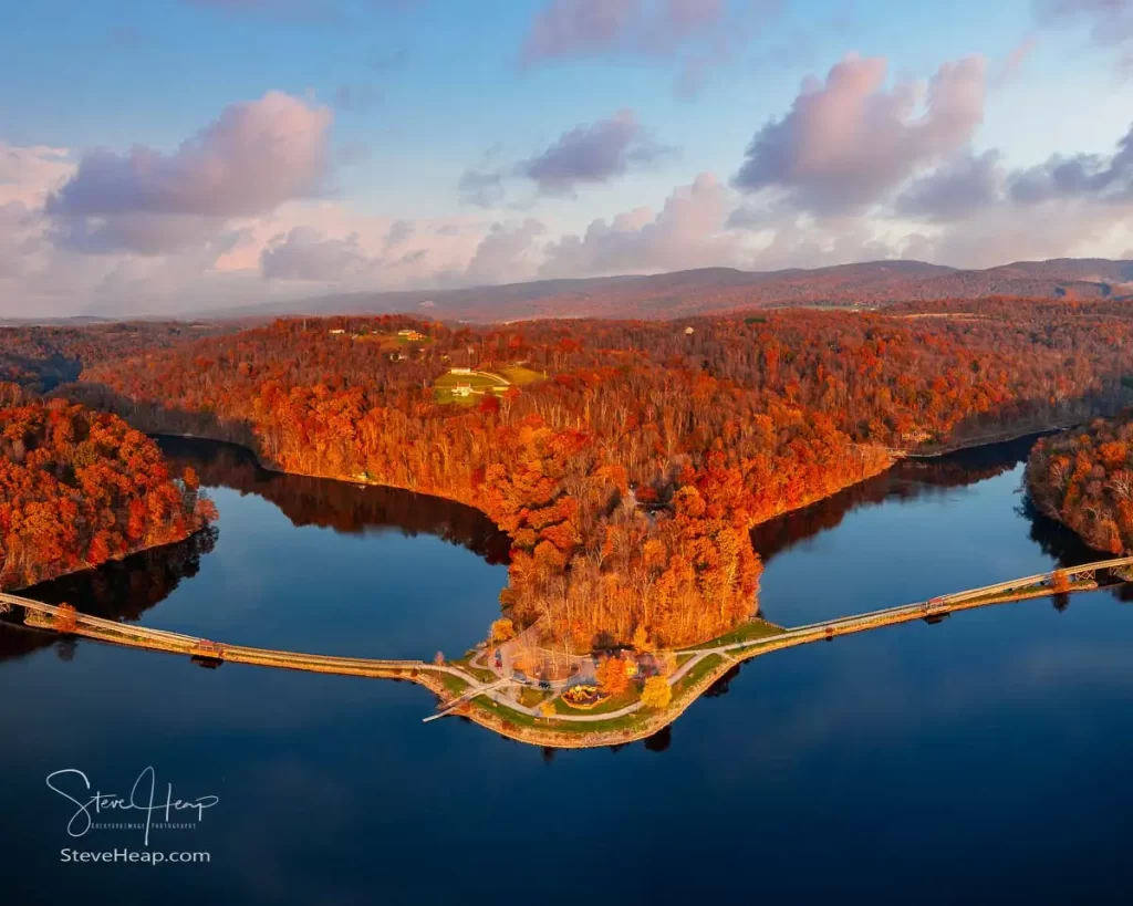 Sun setting casts warm light on the park at Cheat Lake near Morgantown West Virginia on a beautiful calm autumn day
