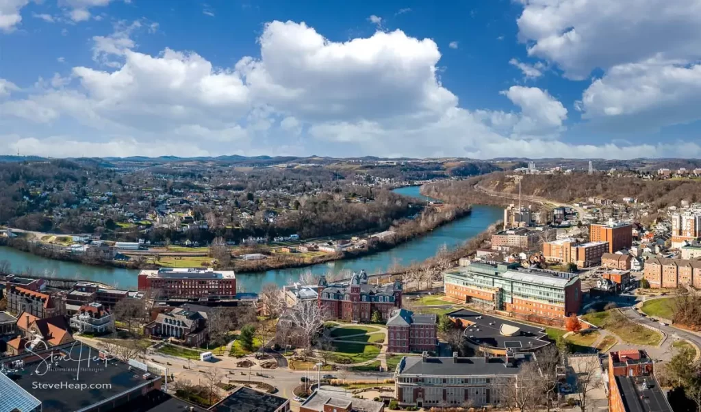 Aerial drone panoramic shot of the downtown campus of WVU in Morgantown West Virginia showing the river in the distance