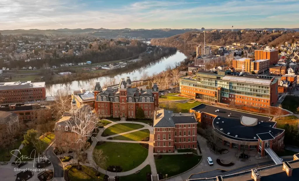 Aerial drone panoramic shot of the downtown campus of WVU in Morgantown West Virginia showing the river in the distance