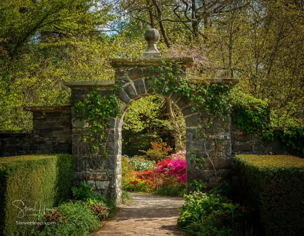 Stone archway leading to a secret garden at Bodnant in North Wales