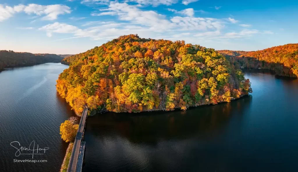 Warm light on the park at Cheat Lake near Morgantown West Virginia on a beautiful calm autumn evening taken from a drone above the water