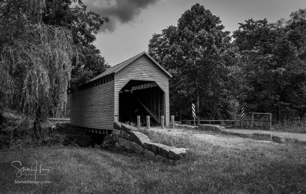 Black and white version of the Dents Run Covered Bridge is a historic covered bridge located near Laurel Point Monongalia County West Virginia. Kingpost truss construction in 1889