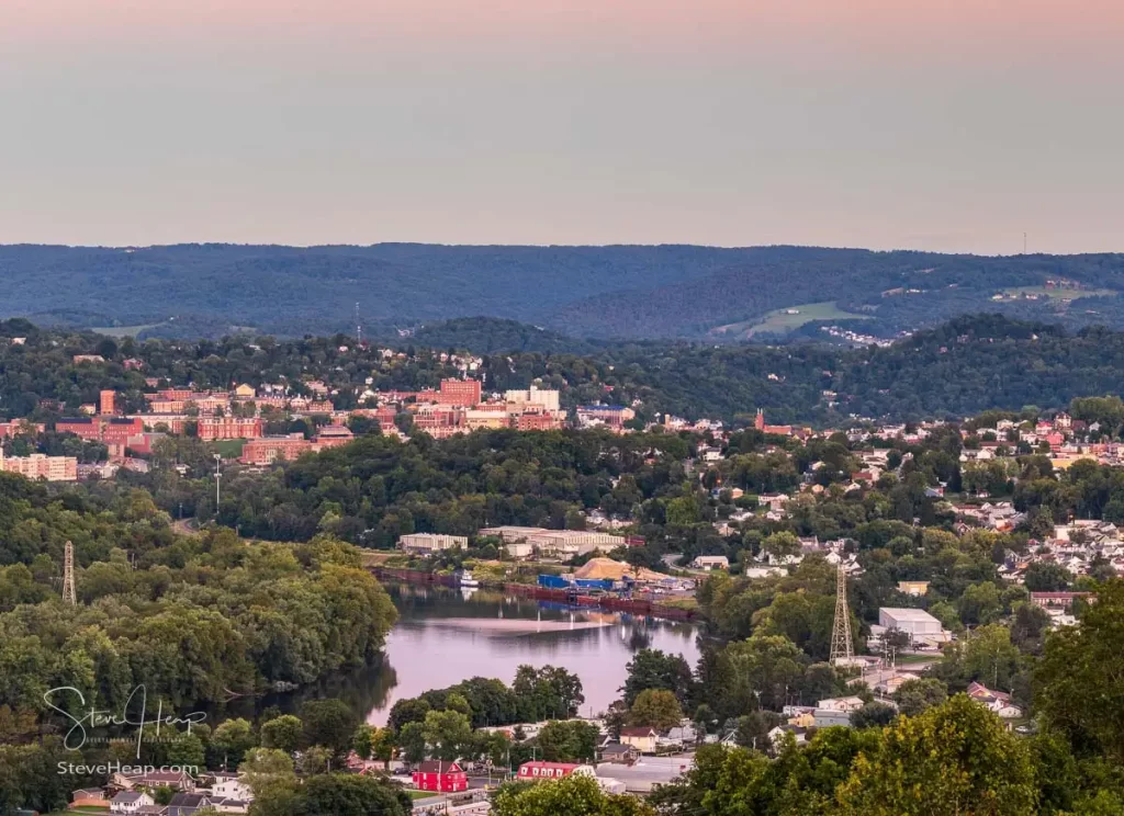 Cityscape of the cities of Granville and Morgantown in West Virginia at dusk with interesting sunset lighting the sky and reflecting in the river