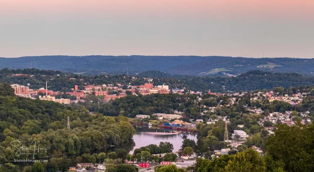 Cityscape of the cities of Granville and Morgantown in West Virginia at dusk with interesting sunset lighting the sky and reflecting in the river