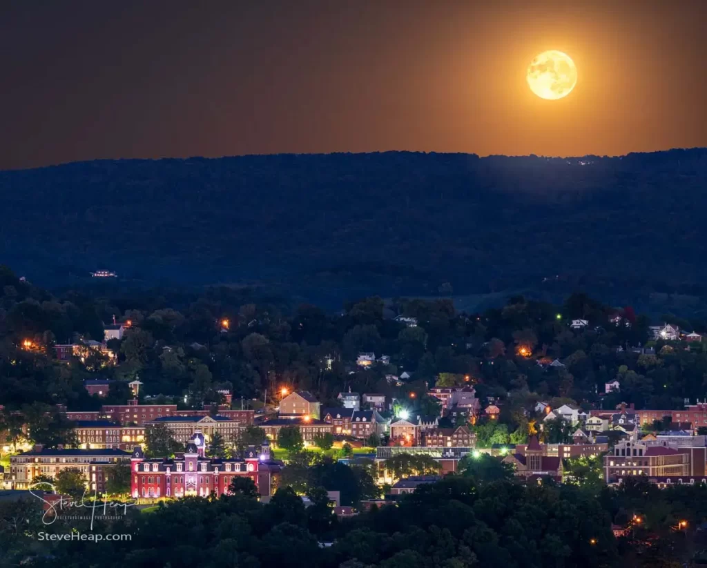 Cityscape of the city of Morgantown in WV as supermoon rises over the town and West Virginia downtown university campus