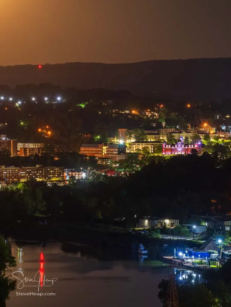 Cityscape of the city of Morgantown in WV as supermoon rises over the town and West Virginia downtown university campus