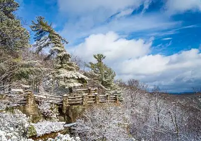 Stone clad Coopers Rock State Forest overlook after a heavy snowfall covering the trees and landscape near Morgantown West Virginia