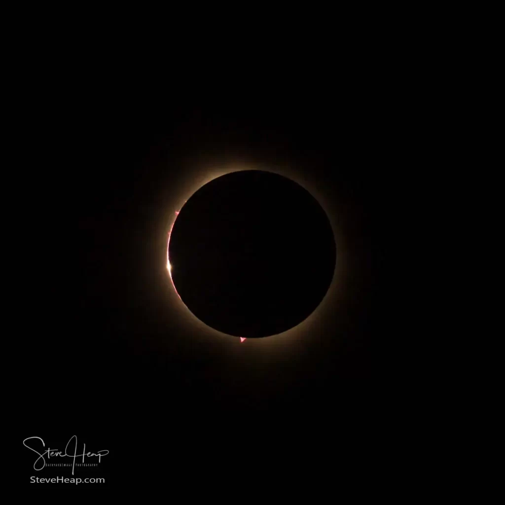 Full eclipse of the sun with the only light now coming through the mountain valley on the surface of the moon - Baily's Beads