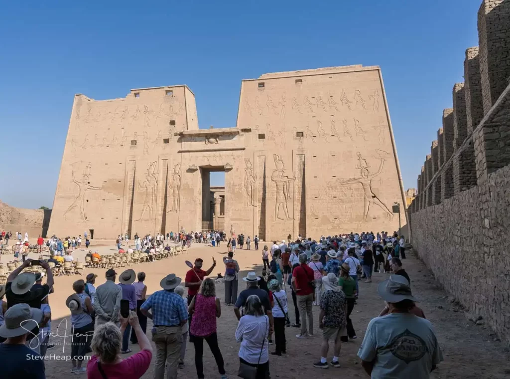 Tourists hearing the story of the Edfu temple from their guides
