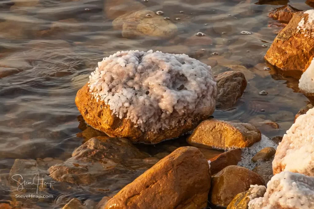 Salt drying on the rocks along the coastline of the Dead Sea
