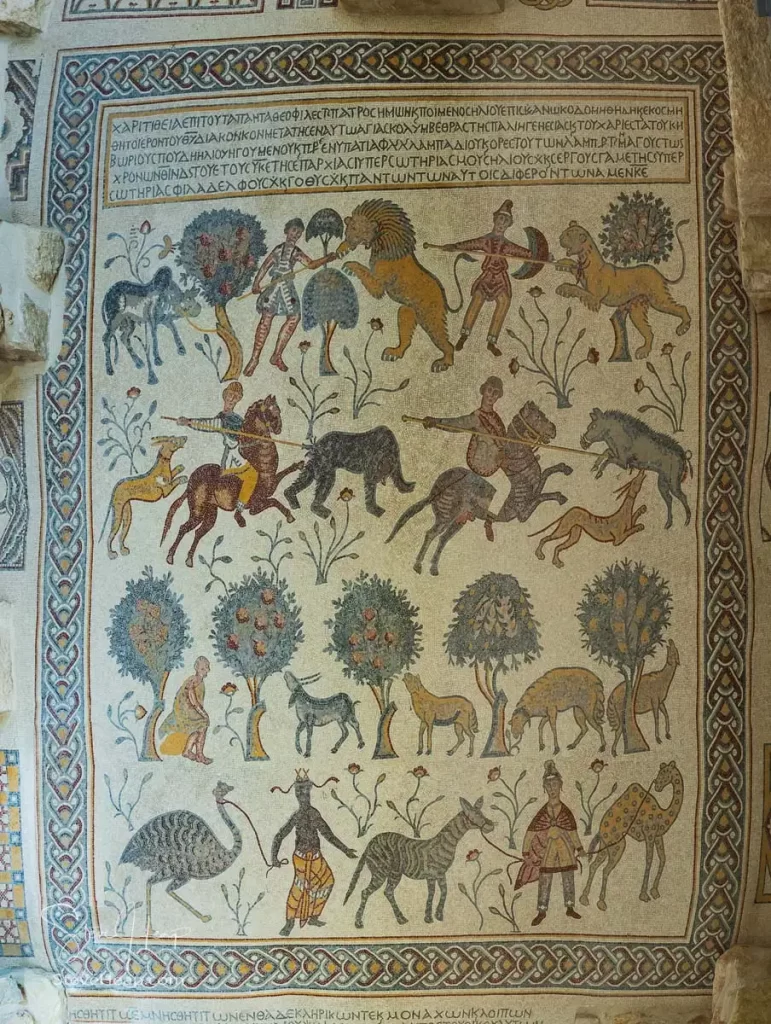 Intricate mosaic illustrating scenes with animals and figures, showcasing the artistic heritage found within the Moses Memorial Church at Mount Nebo.