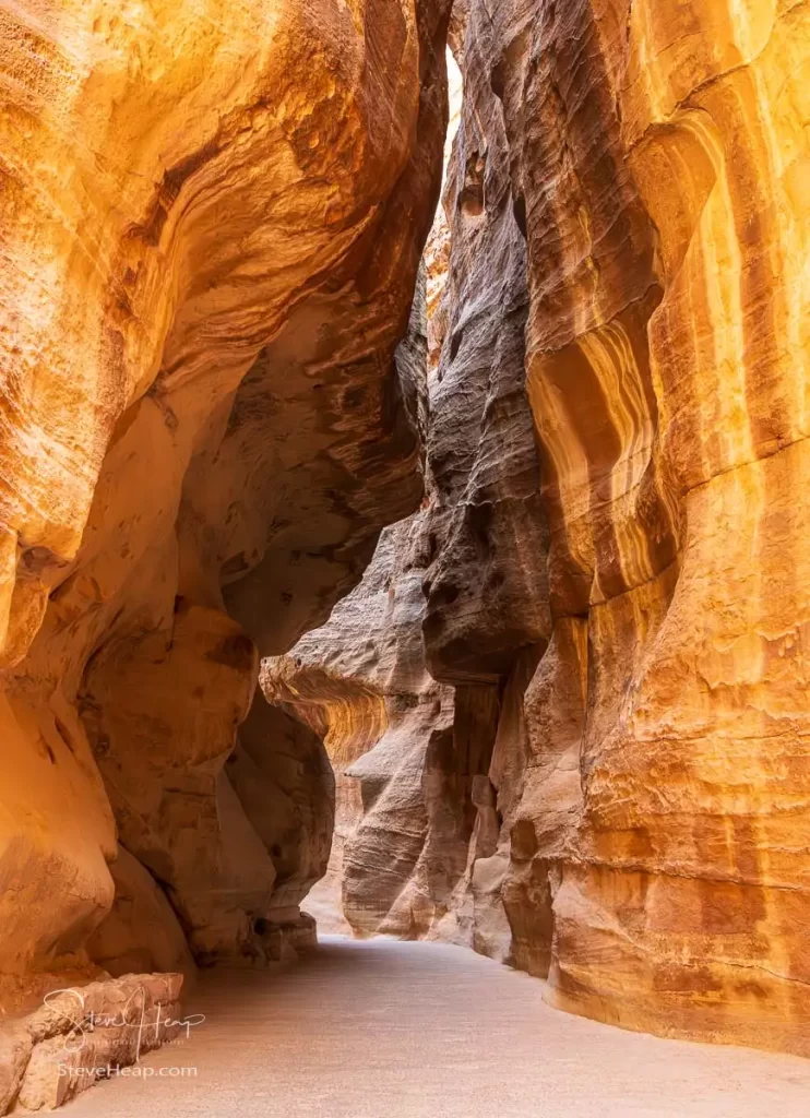 Water carved canyon walls of the narrow gorge of the Siq entering Petra in Jordan