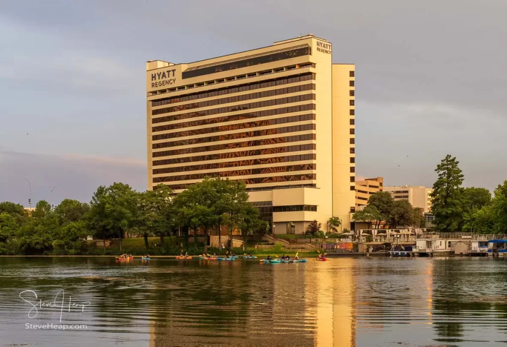 Boats depart from the waterfront by the Hyatt Regency Hotel alongside Congress Avenue
