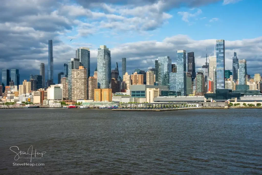 Tall office and apartment buildings along the waterfront in Manhattan by Pier 78 and ferry terminal