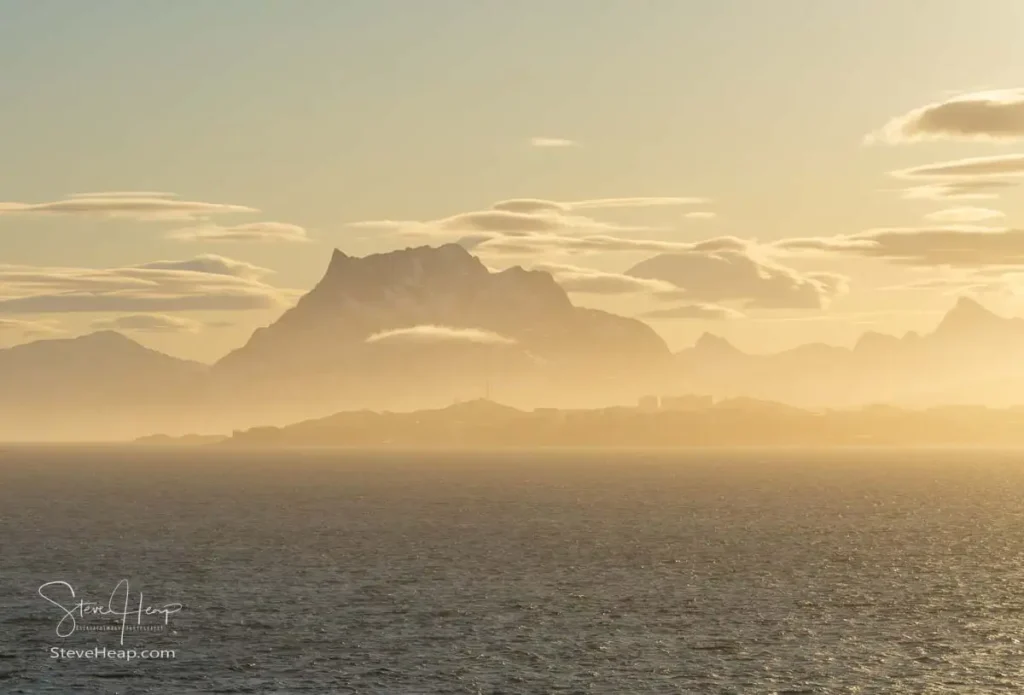 Sermitsiaq mountain dominates the city skyline of the capital city of Nuuk in Greenland on misty arrival by sea