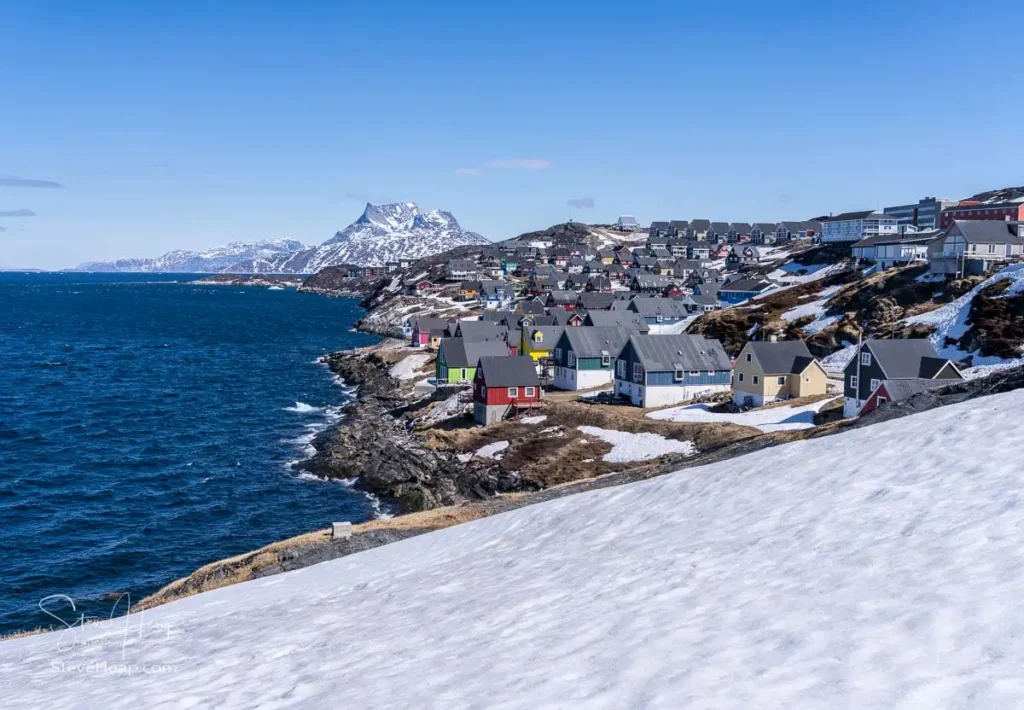 Scenic view of colorful houses nestled along the coast of Nuuk, Greenland, with Sermitsiaq mountain in the background