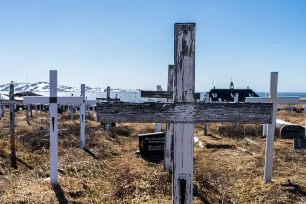 Simple white wooden crosses in Cemetery on Noorlemut street in Nuuk Greenland by the ocean