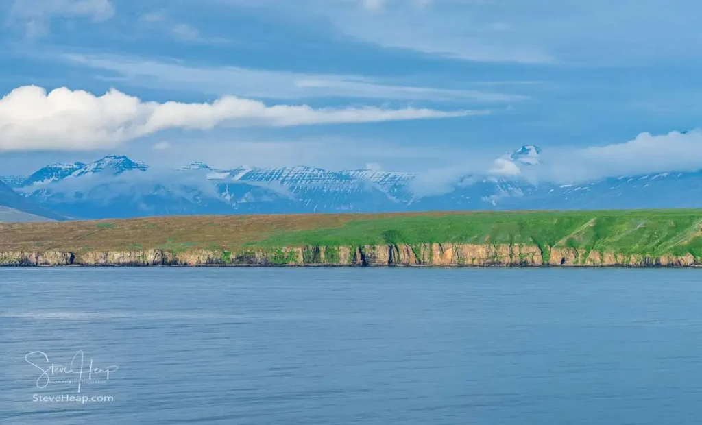 Low islands along our cruise with mountains in the distance as we approached Akureyri in Iceland