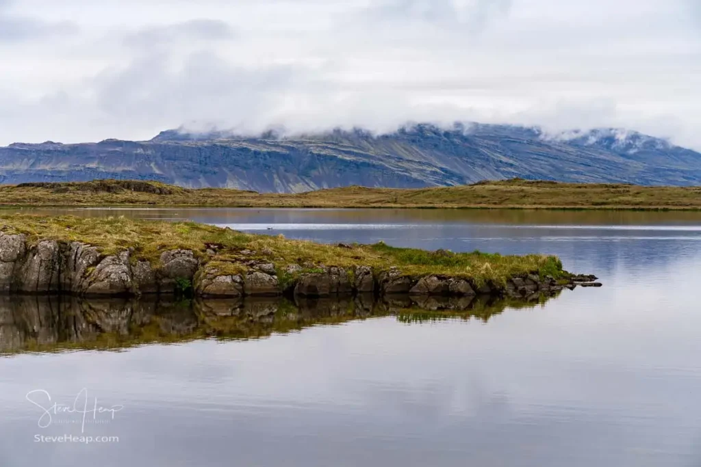 Birdlife watching lagoons in town of Djupivogur in Eastern Iceland leading to the black sand beach of Bulandsnes