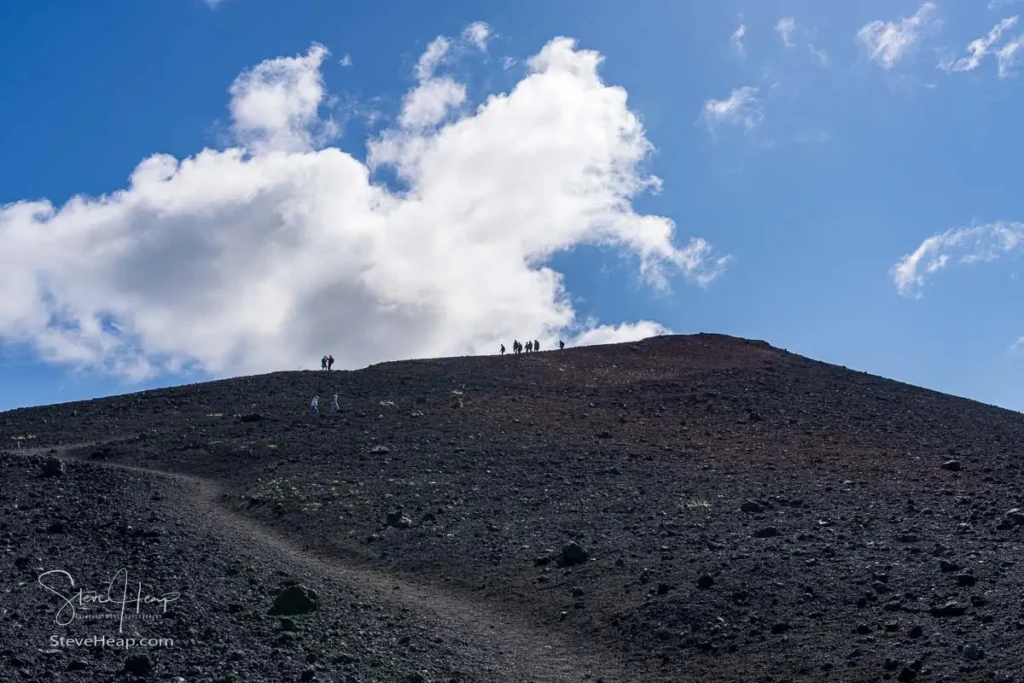 Hikers on the long climb up the lava around the crater of Eldfell, the volcano that erupted in 1973 on Heimaey Island