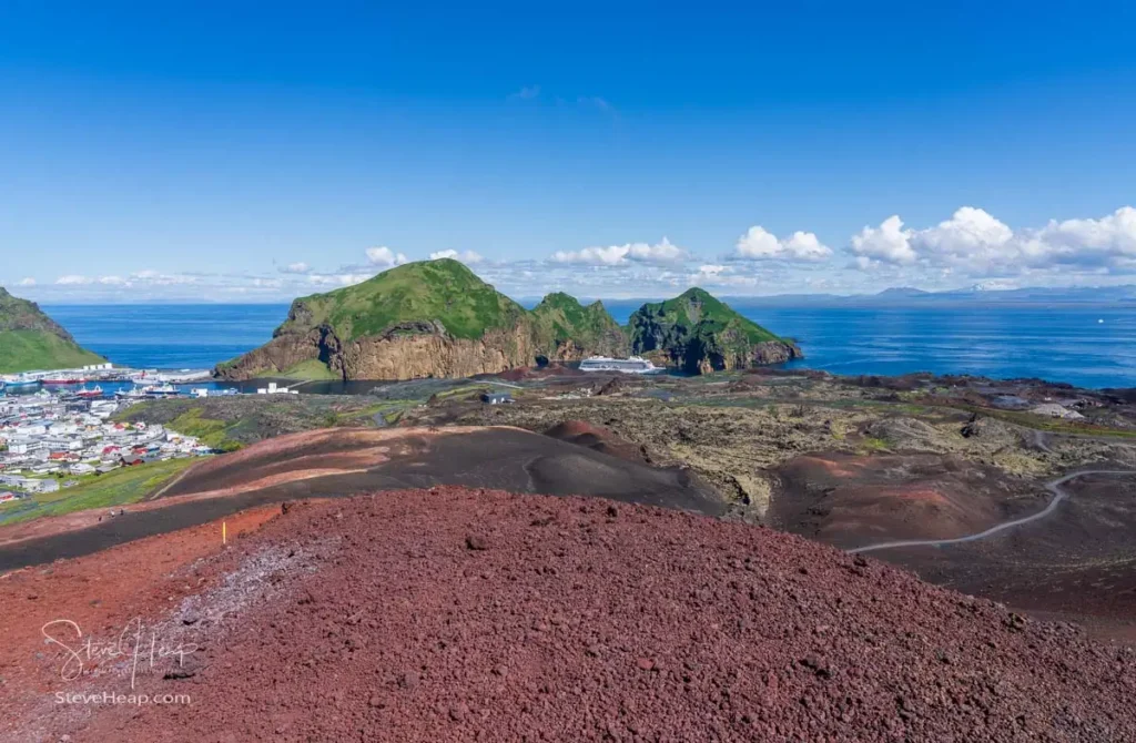 View from summit of Eldfell volcano of the town and harbor with cruise ship anchored on the Island of Heimaey in Iceland