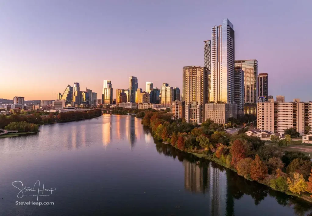 Aerial panoramic skyline of Austin Texas from the east at dusk or sunset in December 2025 with fall colors and clear sky