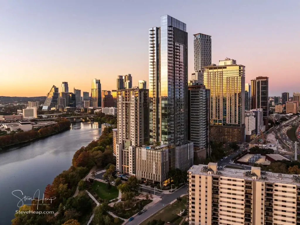 Aerial panoramic skyline of Austin Texas from the east at dusk or sunset in December 2025 with fall colors and clear sky