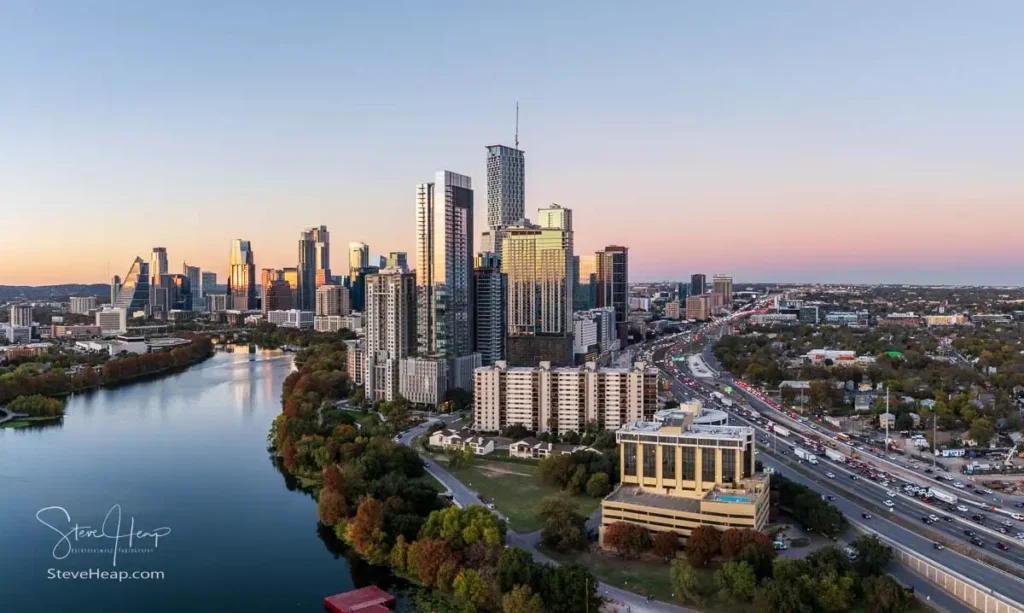 Aerial panoramic skyline of Austin Texas from the east at dusk or sunset in December 2025 with fall colors and clear sky