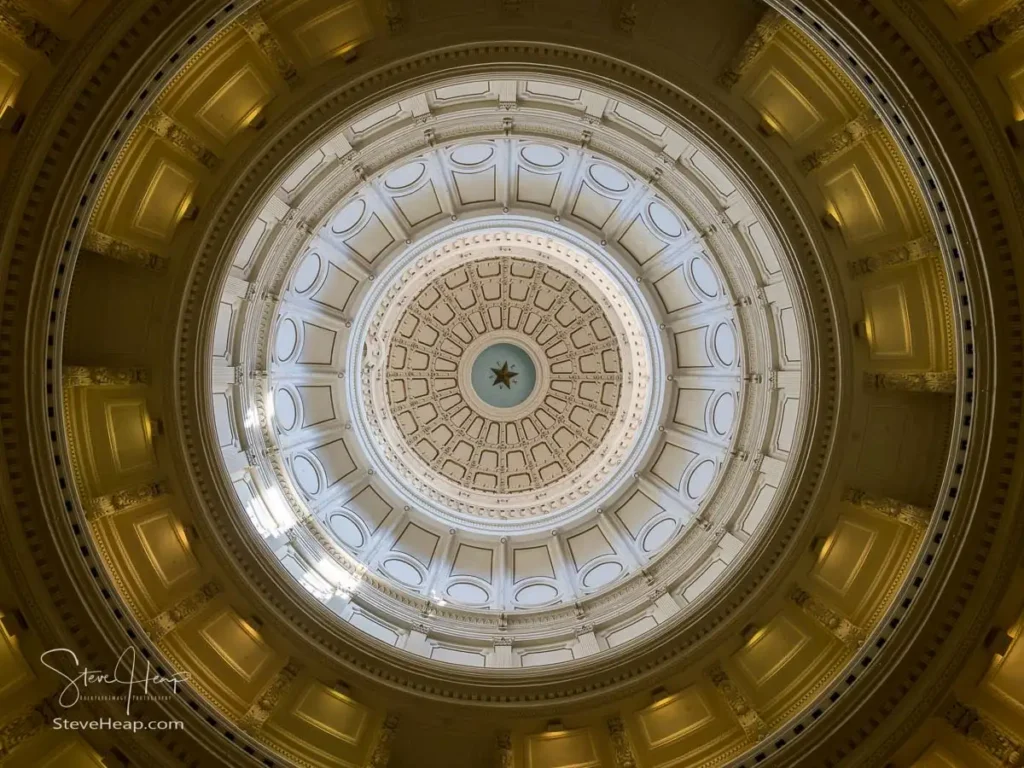 Looking up inside the Texas State Capitol in Austin at the domes design and intricate details
