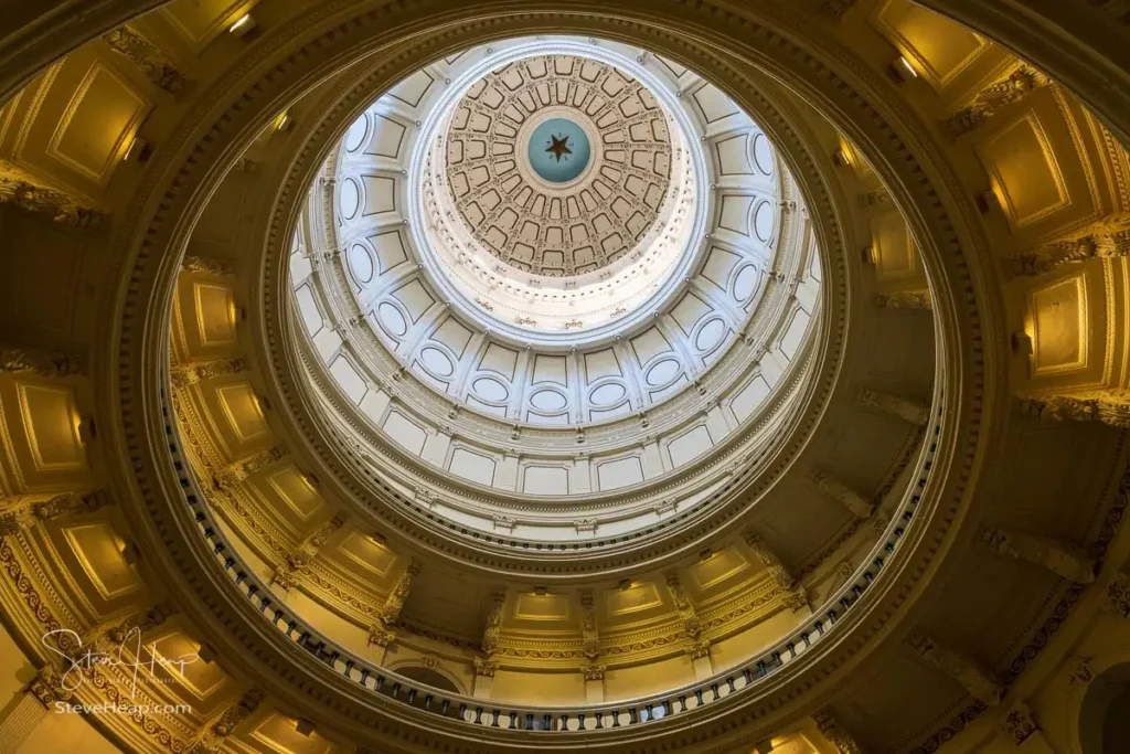 Looking up inside the Texas State Capitol in Austin at the domes design and intricate details